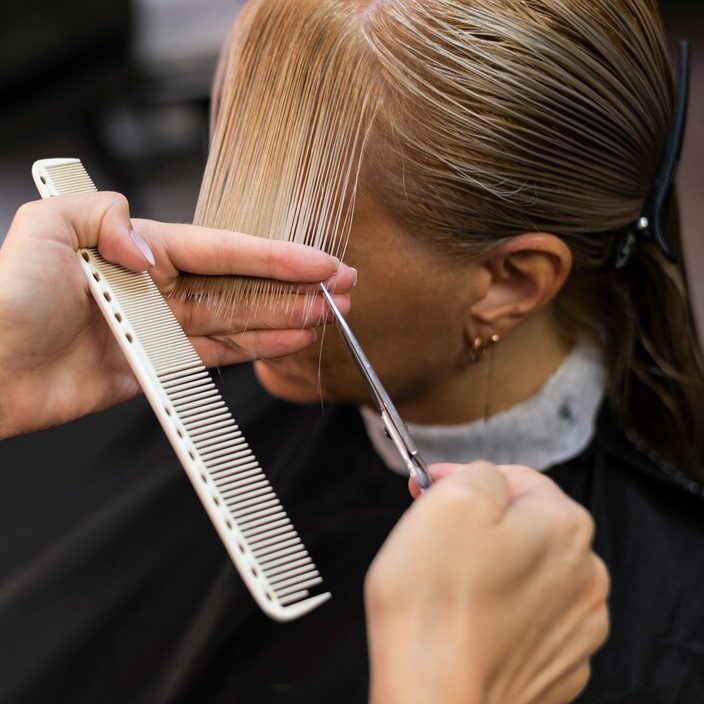 woman-getting-her-hair-cut-beauty-salon_23-2149167396